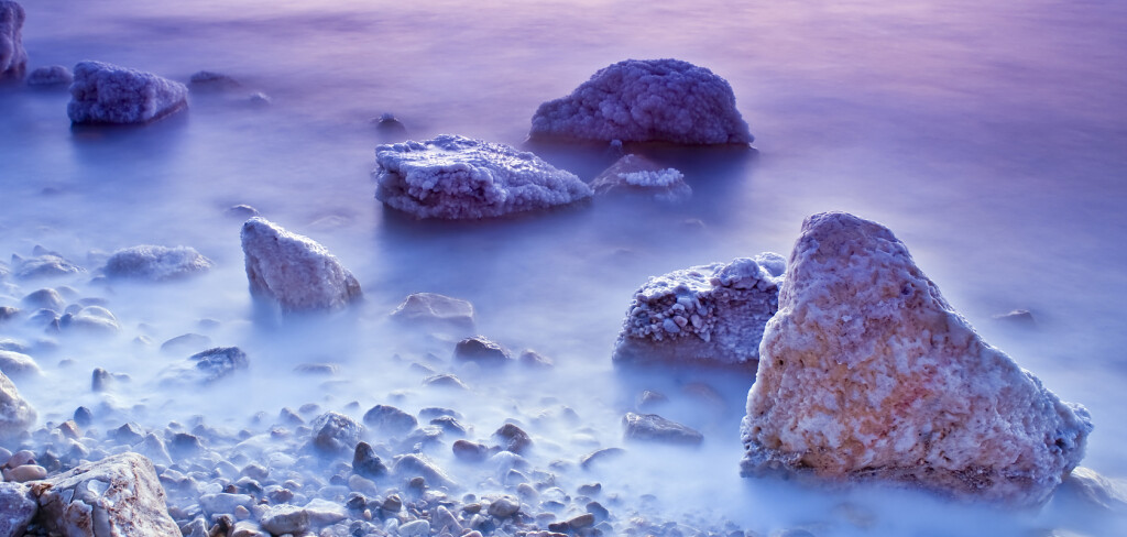 sunrise over the dead sea with waves in motion blur