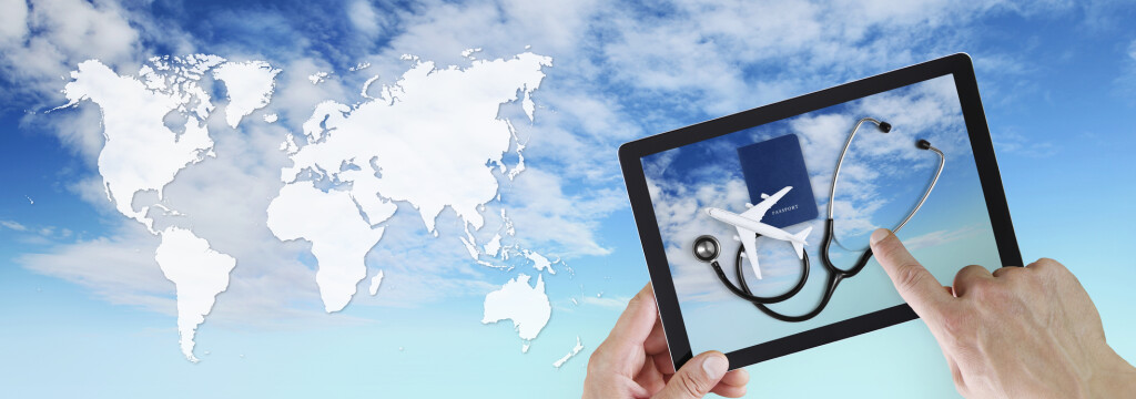 international medical travel insurance concept, hand touch screen of digital tablet with stethoscope, passport and airplane, on sky background with global map