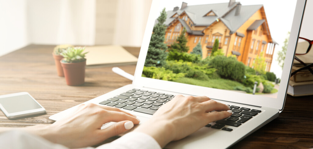 Online shopping concept. Woman looking for house on real estate market website