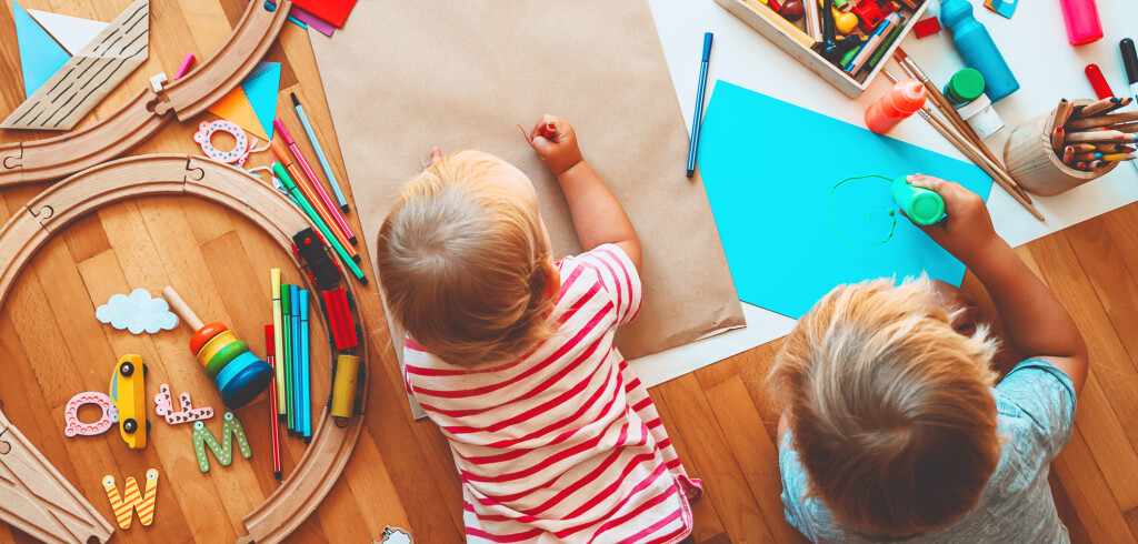 Kids draw and make crafts. Children with educational toys and school supplies for creativity. Background for preschool and kindergarten or art classes. Boy and girl play at home or daycare