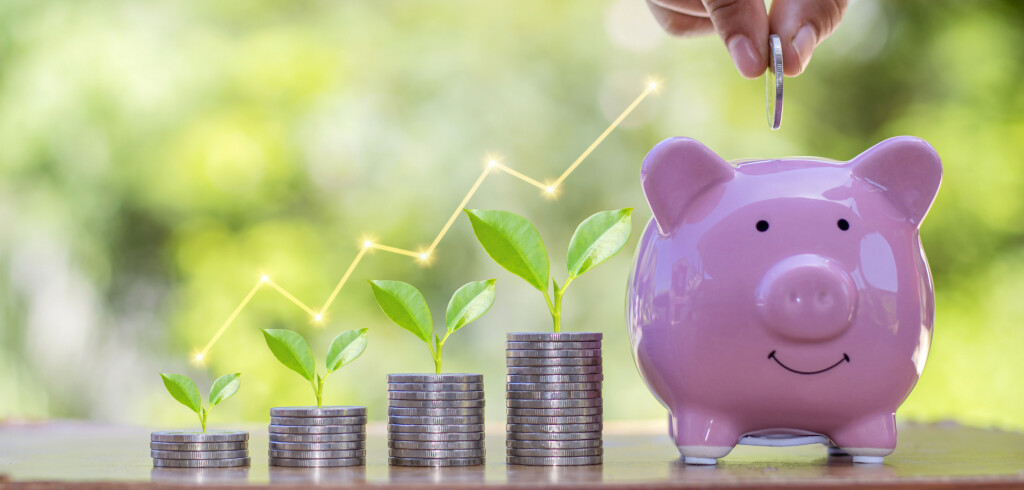 Planting seedlings on a pile of coins and a graph showing financial growth, investment concepts and business growth.