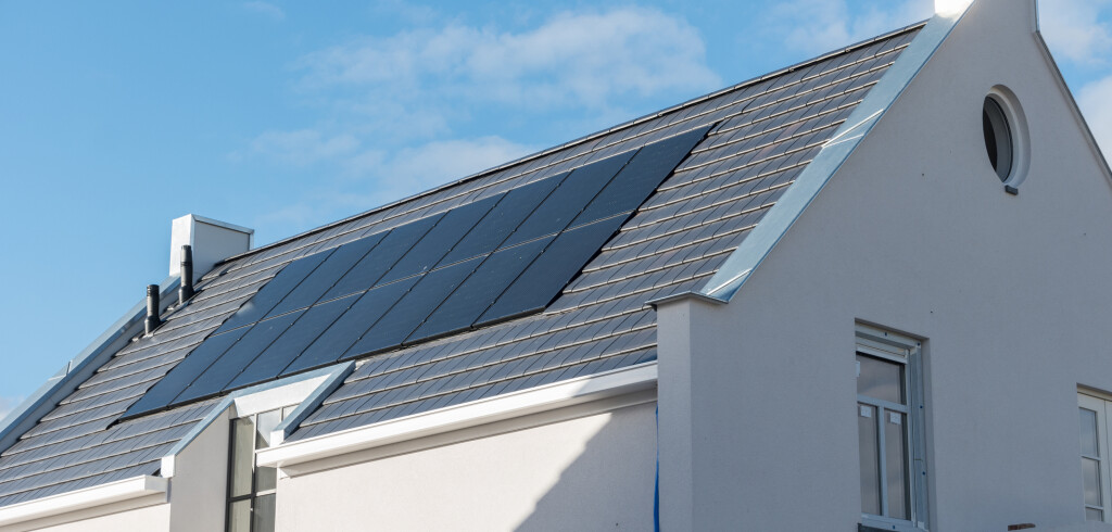 Newly build house in the Netherlands with solar panels attached on the roof against a sunny sky of new building black solar panels Flevoland