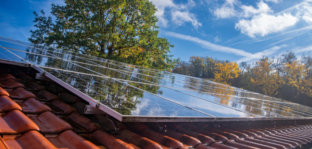 Wet photovoltaic modules in front of blue and cloudy autumn sky. High quality photo