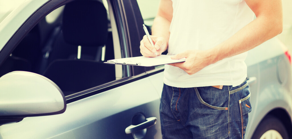 transportation and ownership concept - man with car documents