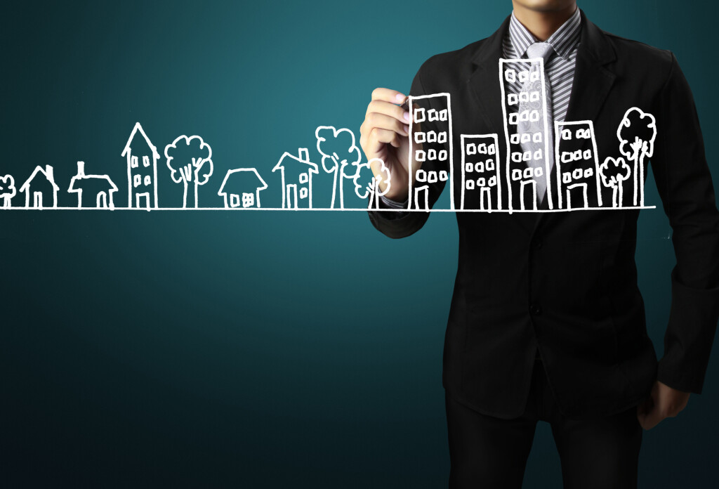 Business man drawing a house