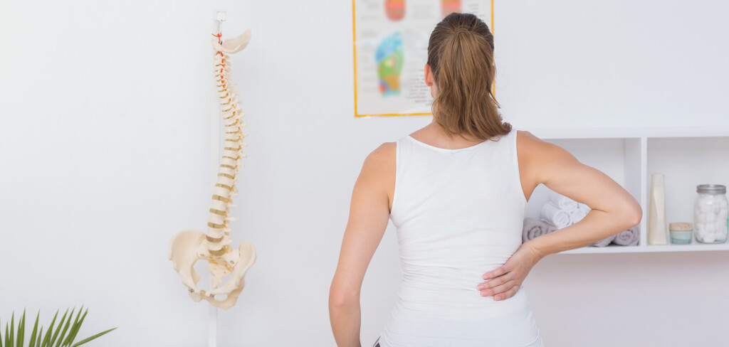 Wear view of patient with back pain in medical office