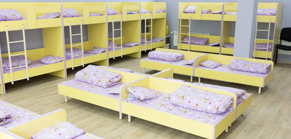 Modern kindergarten bedroom with small bunk beds with stairs for the kids.